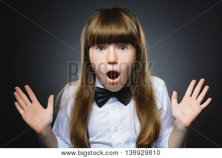 Closeup Portrait of wondering girl going surprise on gray background.