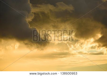 Background Of Golden Storm Clouds At Sunset.