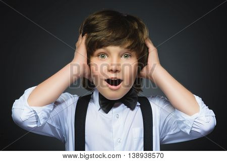 Closeup Portrait of happy boy going surprise isolated on gray background.