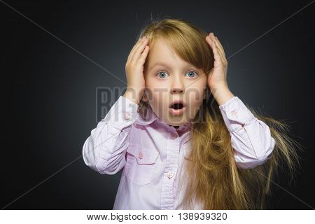 Closeup Portrait of wondering girl going surprise on gray background.