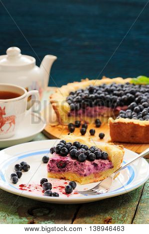 Homemade tart with cottage cheese filling and fresh organic forest blueberries copyspace