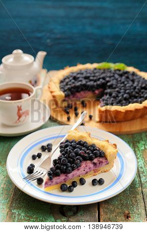 Homemade tart with cottage cheese mousse and fresh organic forest blueberries vertical