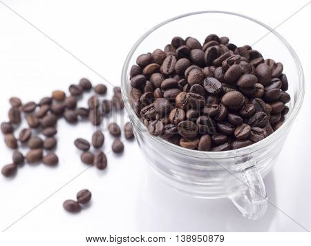 heap of coffee beans isolated on a white background from glass jar