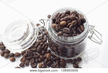 heap of coffee beans isolated on a white background from glass jar