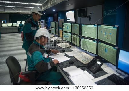 Tobolsk, Russia - July 15. 2016: Sibur company. Central control panel of Tobolsk Polymer plant. The engineering personnel watch in monitors work of the equipment