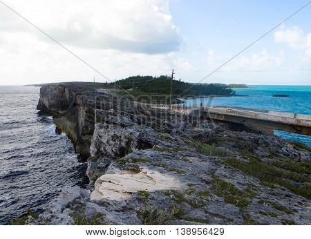 Picture of the Glass Window Eleuthera Bahamas sunny, clear and peaceful on the Caribbean side, overcast, cloudy and rough on the Atlantic side.