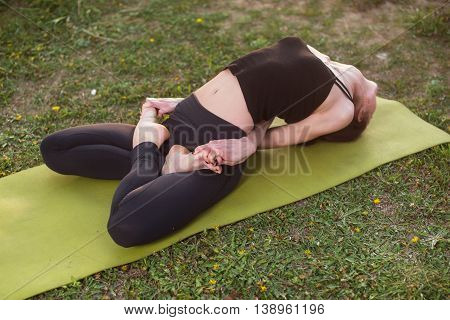 woman practicing outdoors meditating in yoga position