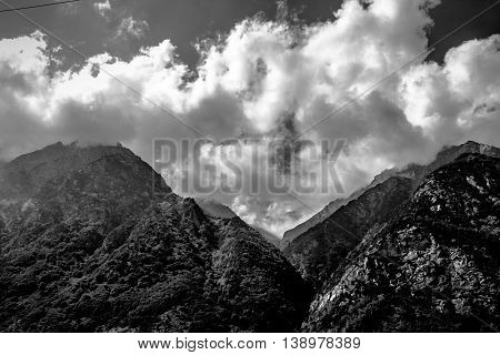it is black a white landscape, mountains, clouds