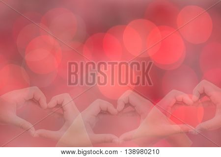 kid hands making a heart shape with sweet background