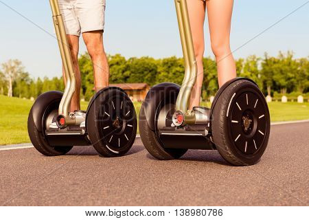 Close Up Photo Of Two People Riding Electric Segways