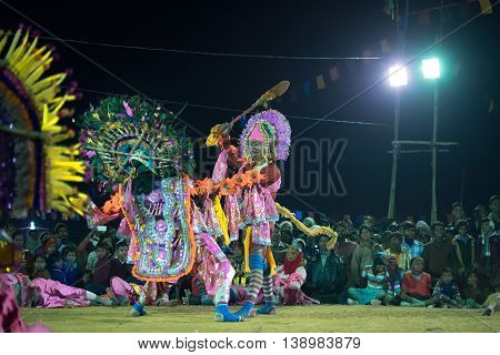 BAMNIA PURULIA WEST BENGAL INDIA - DECEMBER 23RD 2015 : Dancer dressed as Hanumanji is killing monster Chhau Dance festival. It is a very popular Indian tribal martial dance performed at night amongst spectators.