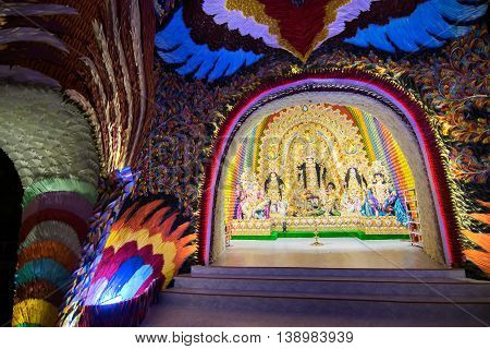KOLKATA INDIA - OCTOBER 18 2015 : Night image of decorated Durga Puja pandal shot at colored light at Kolkata West Bengal India. Durga Puja is biggest religious festival of Hinduism.