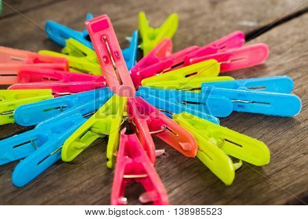 Colorful clothes peg, clothespin on wood background use for dry the clothes under the sun