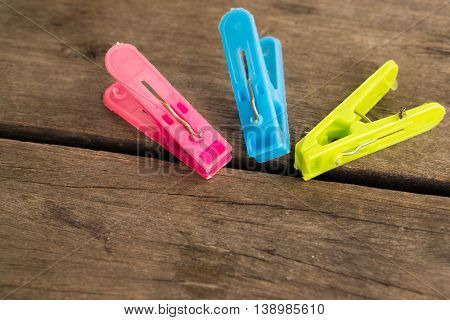Colorful clothes peg, clothespin on wood background use for dry the clothes under the sun