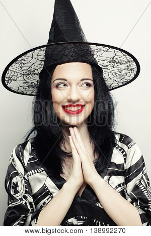Funny Witch. Young happy woman with canival hat. Studio shot.