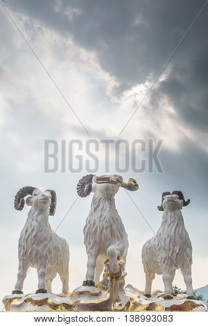REPULSE BAY HONG KONG - MAY 23: The statues of three celestial rams with sunlight comes through clouds like the God blesses the earth in Kwun Yam temple on May 23 2016 in Repulse Bay Hong Kong.