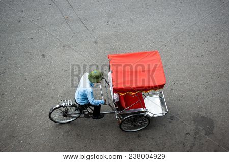 Cyclo Or Pedicab Driver On Hanoi Street