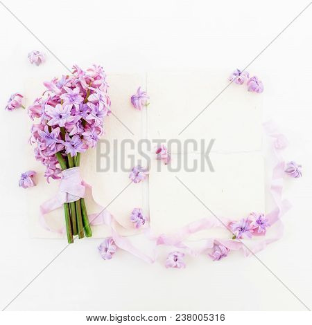Bouquet Of Pink Hyacinth Flowers And Tapes With Cards On White Background. Flat Lay, Top View.