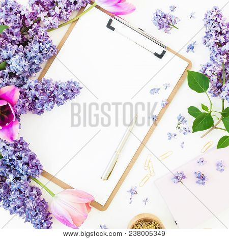 Minimalistic Workspace With Clipboard, Envelope, Pen, Lilac, Petels And Accessories On White Backgro