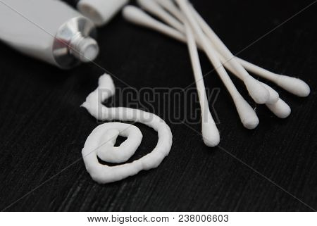 Medical. Ointment Tub Isolated On Black. Applying The Ointment And Emollient Cream