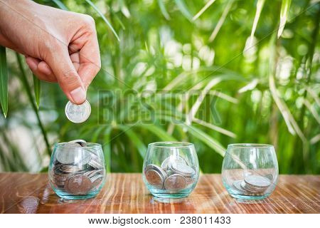 Hand Of  Female Putting Coins In Jar With Money Stack Step Growing Growth Saving Money