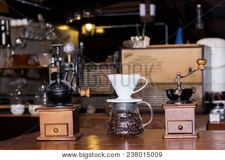 Coffee Grinder With Coffee Beans In Glass On The Table