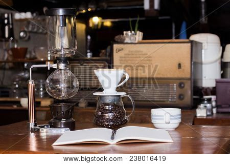 Black Coffee Cup And Wooden Desk Diary