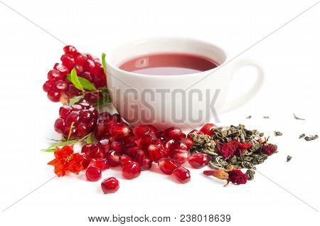 Parts Of A Pomegranate With Pomegranate Seeds And Leaves, Flowers, Dry Tea Of Carcade And Full Cup O