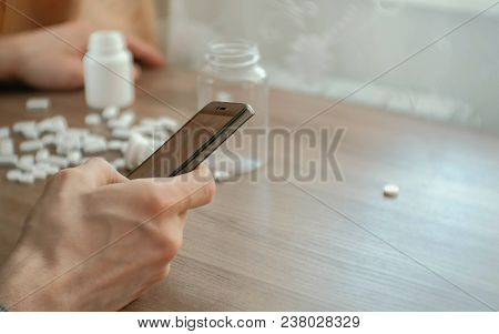 Man Tries To Call For Help On The Mobile Phone. The Concept Of Depression, Suicide And Danger