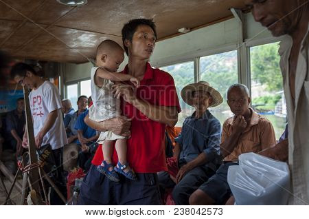 Yangshuo, China - August 2, 2012: People Traveling In A Boat In The Li River Near The Town Of Yangsh