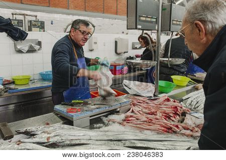 March 24th, 2018 - Olhao, Portugal: Fishmonger Selling Fish To A Client At The Fish Market In Olhao,