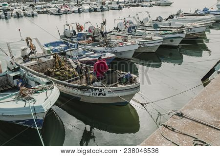 March 24th, 2018 - Olhao, Portugal: Fisherman Working And Repairfisherman Working And Repairing Nets