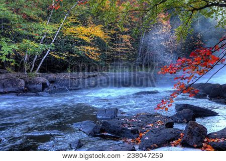 An Algonquin River Rapids With Colorful Foliage In Autumn