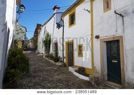 View Of A Narrow Cobblestone Street Inside The Walls Of The Castle Of The Village Of Nisa, Alentejo,