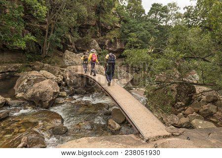 Royal Natal National Park, South Africa - March 14, 2018: Park Employees Walking On The Bridge Over 