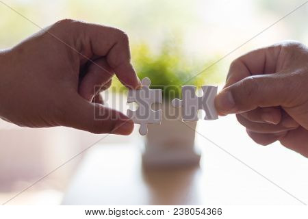 The Hands Of Businessmen Who Are Connecting  Jigsaw, The Concept Of Doing Business Together.