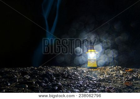 Luminous Hand Lantern Standing On The Rocks On The Background Of Orekhovsky Waterfall At Dusk, Sochi