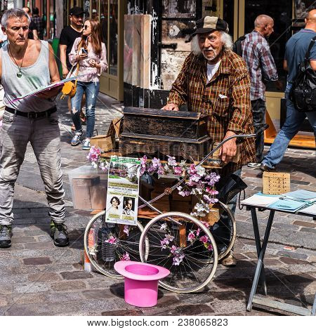 Paris, France - Jule 09, 2017: Old Organ Grinder Musician With Decorated Barrel Organ (hurdy Gurdy) 
