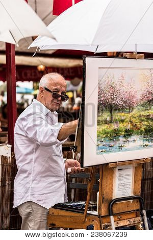 Paris, France - July 06, 2017: The Painter Works At The Open Air Artist Market At The Tertre Square 