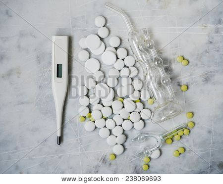 Pill Thermometer And Inhaler On A Light Background. Healthcare.
