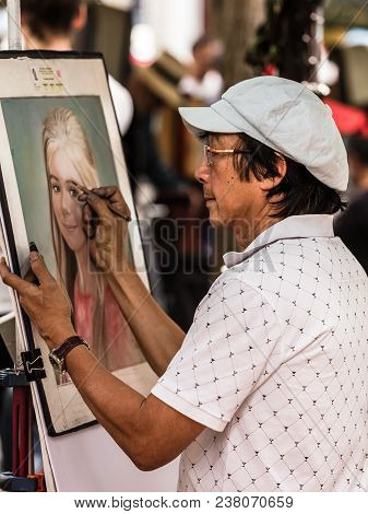 Paris, France - July 06, 2017: The Painter Works At The Open Air Artist Market At The Tertre Square 