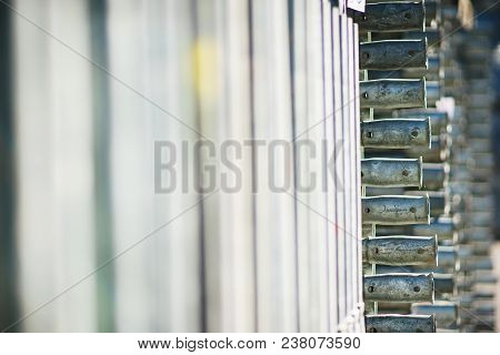 Metal Structures In A Warehouse In Stacks. Metal Supports For Scaffolding And Formwork. Soft Focus A
