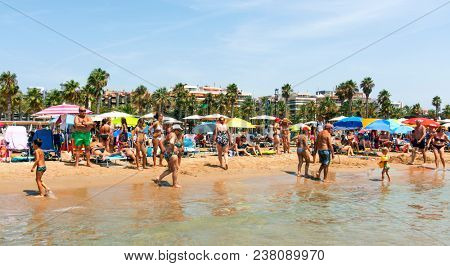 SALOU, SPAIN - AUGUST 3, 2017: Vacationers in the Llevant Beach in Salou, Spain. Salou is a major destination for sun and beach for European tourism, with more than 50,000 accommodations