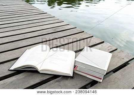 Books On The Wood Floor The Bridge Of Waterside Area Adjoining Lake Or River In Nature Forest Backgr