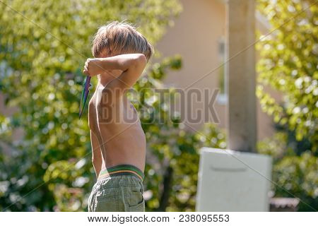 Little Healthy Athletic Boy Practicing In Throwing Kunai