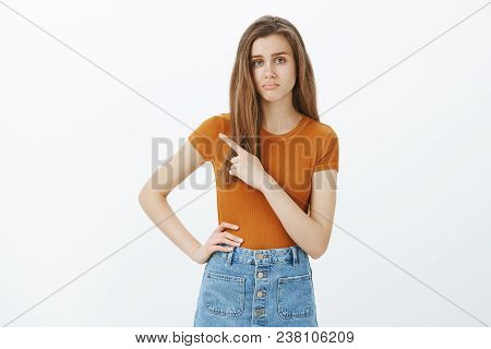Nothing Unsual Here. Indifferent Attractive Female Coworker In Stylish Outfit, Holding Hand On Hip, 