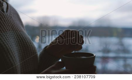 Comfort Relaxation Leisure. Girl Drinking Tea At Home At Dusk. Romantic Calm Twilight Atmosphere. Ev