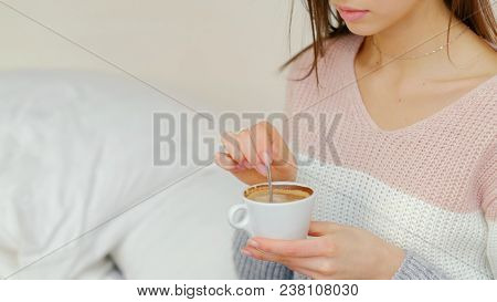 Morning Energy Boost Ritual. Hot Invigorating Beverage. Girl Stirring Coffee In A Cup