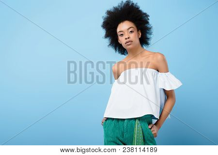 Beautiful African American Woman In Fashionable Off-the-shoulder Top Isolated On Blue