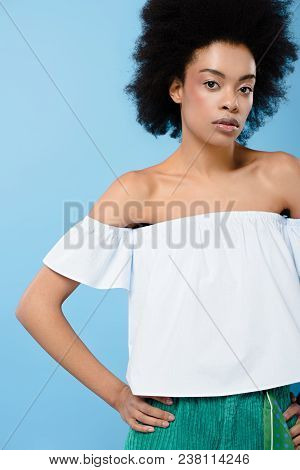African American Woman In Fashionable Off-the-shoulder Top Isolated On Blue